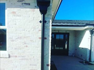 Black fascia with round downspouts #4 leaderhead decorative strap
